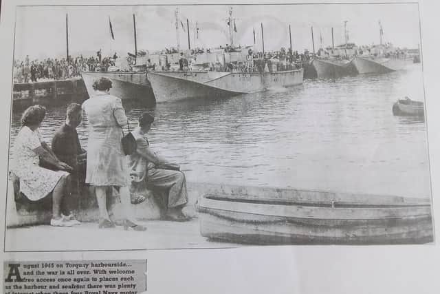 A newspaper or magazine cutting alongside it reads: “…and the war is all over. With welcome free access once again to places such as the harbour and seafront, there was plenty of interest when these four Royal Navy motor torpedo boats paid a visit.”