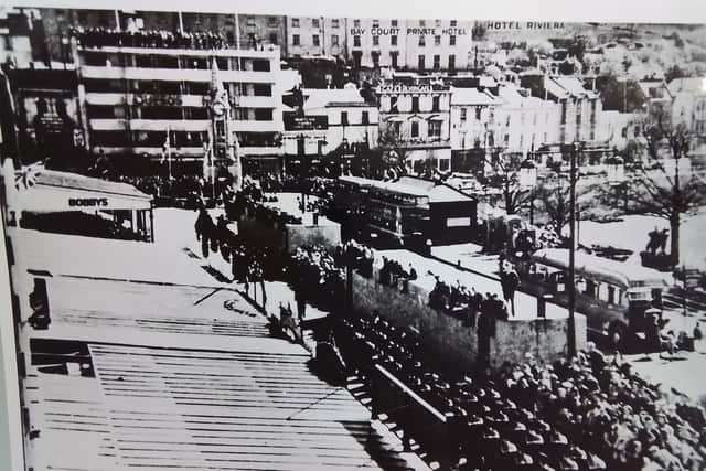 The photographs shown here, kindly provided through our partnership with Torquay library, offer us a glimpse of Torquay and Paignton on the first VE Day in May 1945. One of the photos shows the Victory Parade on the Strand, Torquay, with people gathered on balconies and rooftops to share in the joy and peace.