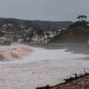 Storm waves crashing onto the pebbled beach at Budleigh Salterton in Devon
