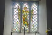 A stained-glass window depicting St Michael 