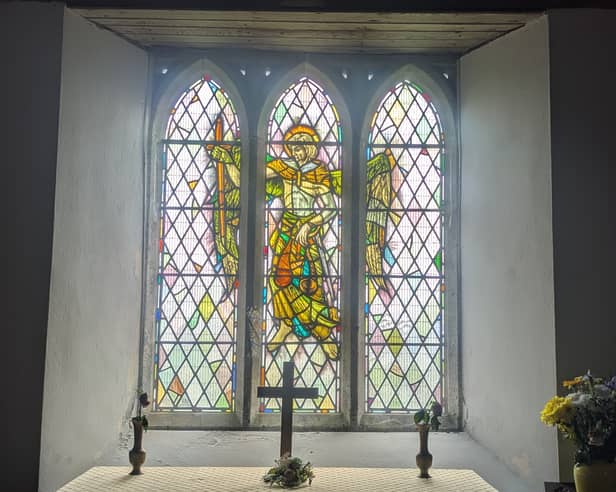 A stained-glass window depicting St Michael 