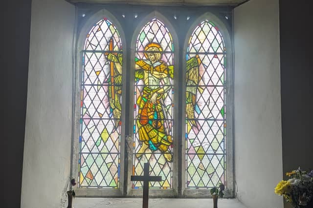 A stained-glass window depicting St Michael