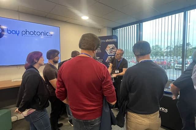 Bay Photonics' Phil Mitchell with a group of AMS visitors