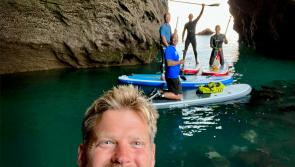 VIDEO: Paddle boarders stunned by wild dolphins