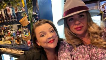 Zoe Gay with hat and bar assistant Abi