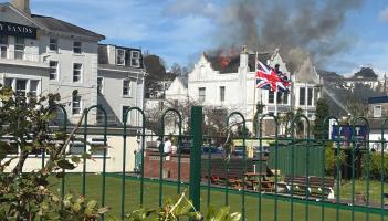 Flames rip through the roof of the empty Sherwood Hotel