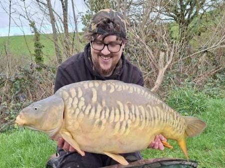Jack Lord with a Mirror Carp from Newbarn Farm Angling Centre weighing 36lbs 8oz