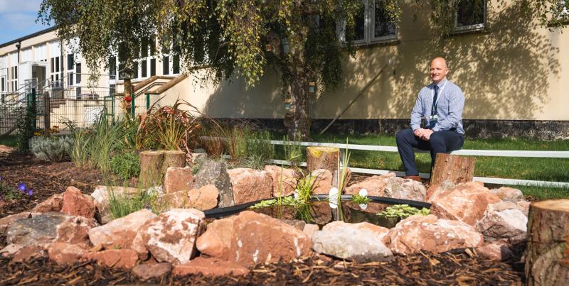 Tim Nield, Headteacher at Watcombe Primary School, in the pond area that Taylor Wimpey Exeter and its contractors and suppliers renovated
