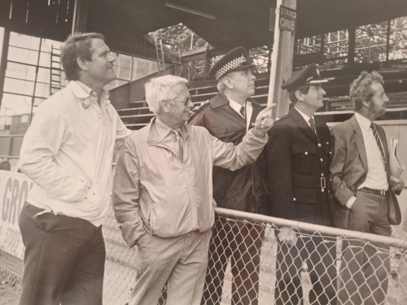 Lew Pope (second left), then Torquay United chairman, inspects Plainmoor's fire-damaged grandstand with Dave Webb, police and fire officers in July 1985. Pic from Torbay News Agency