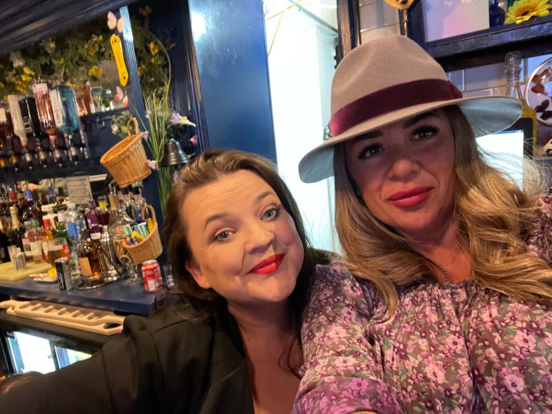 Zoe Gay with hat and bar assistant Abi
