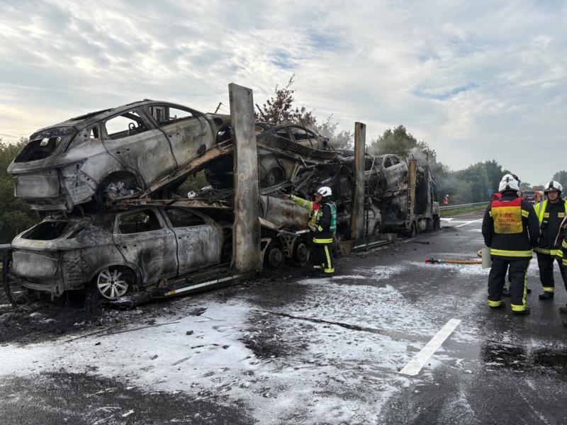 The fire-wrecked transporter and cars on the M5  Pic Devon and Cornwall Roads Policing Team