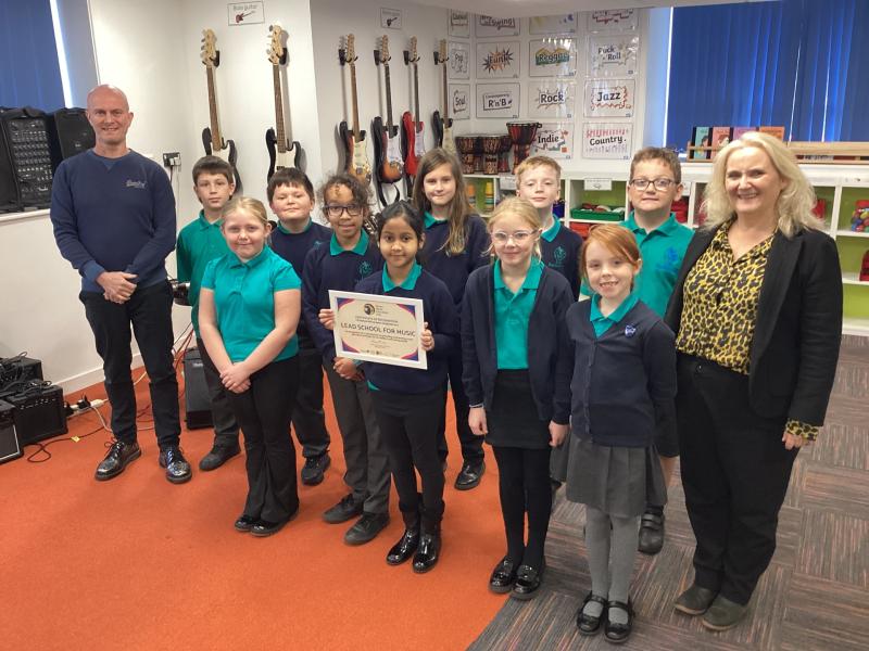 In tune - Lift Barton Hill head Sam Smith, music teacher Mr Gray and pupils 