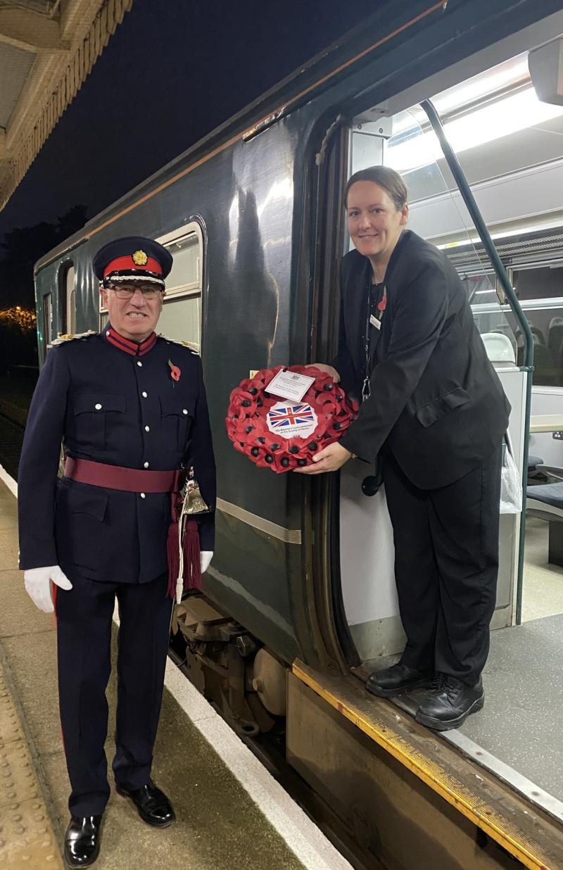 Nick Powe, deputy Lord Lieutenant of Devon, hands over the wreath to a GWR train at Torquay rail station 