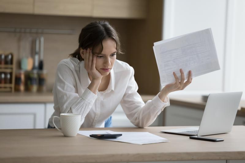 Stressed woman laptop-bills credit Fizkes-Adobe Stock