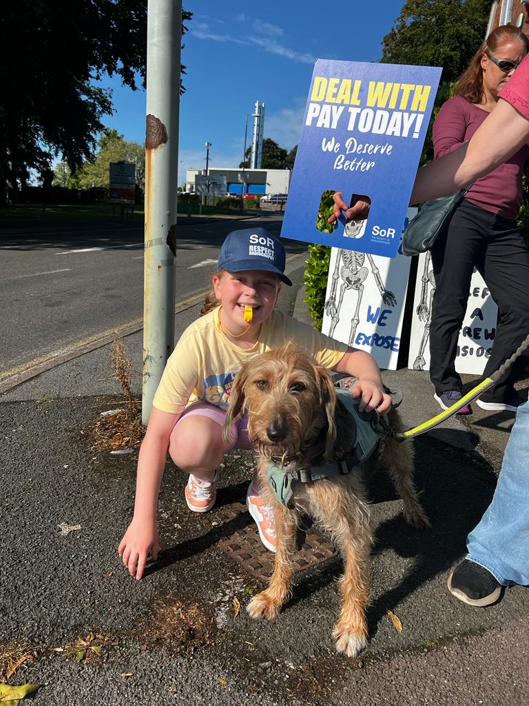 Child and dog on picket line outside Torbay Hospital
