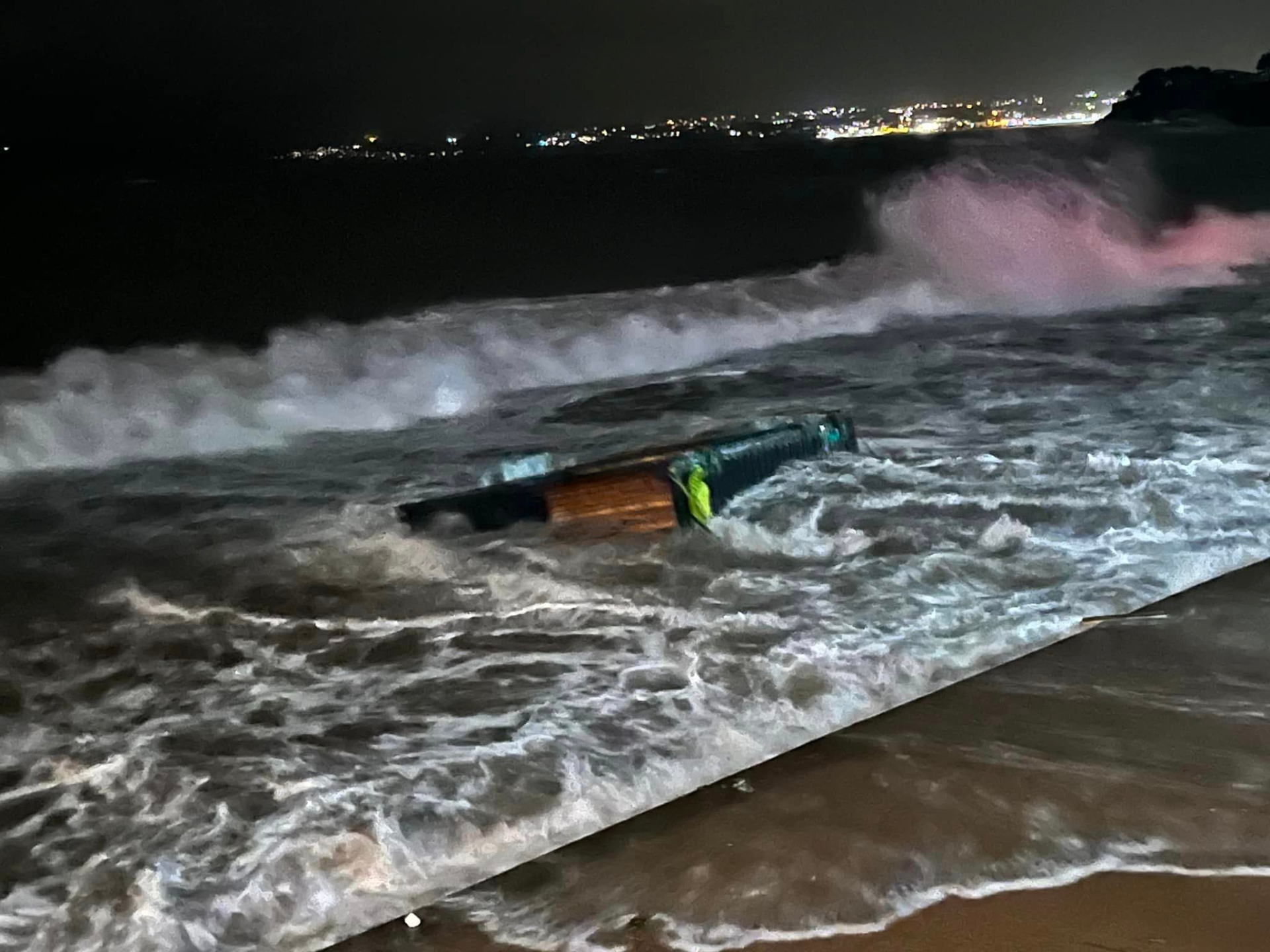 The shippiing container that was once part of the SOAK coffee bar is taken by the waves