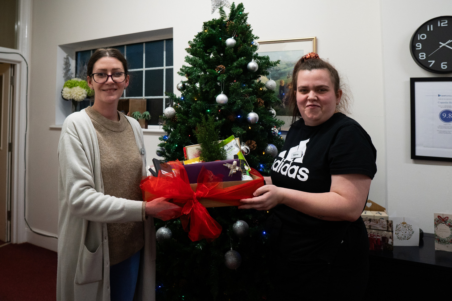Bovey Castle's Miriam Youngson and Reanne Salter donating to Coppelia House care home