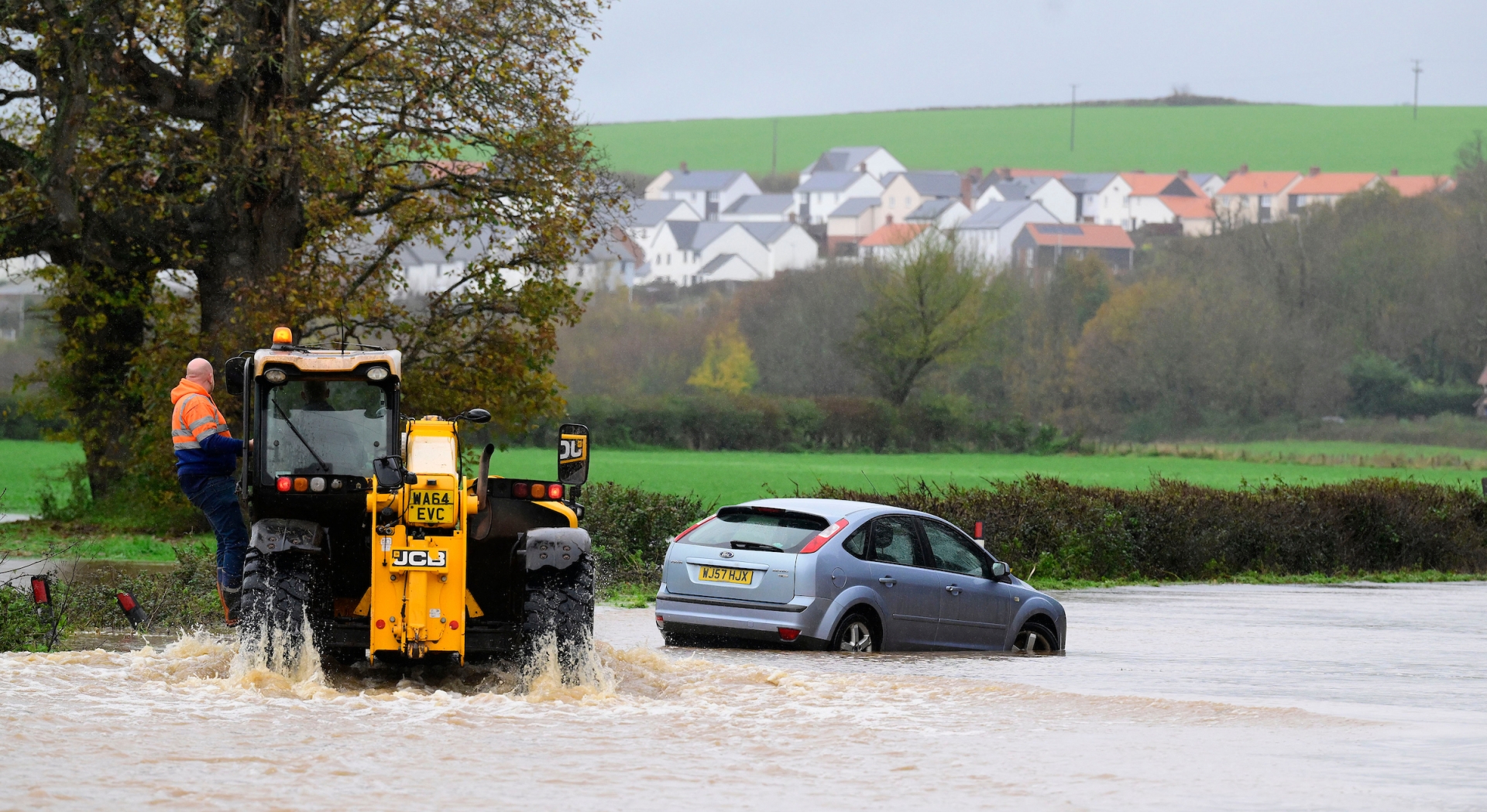 A farmer and his tractor helps a motorist stricken by the Storm Bert floods Pic Phil Mingo Pinnacle
