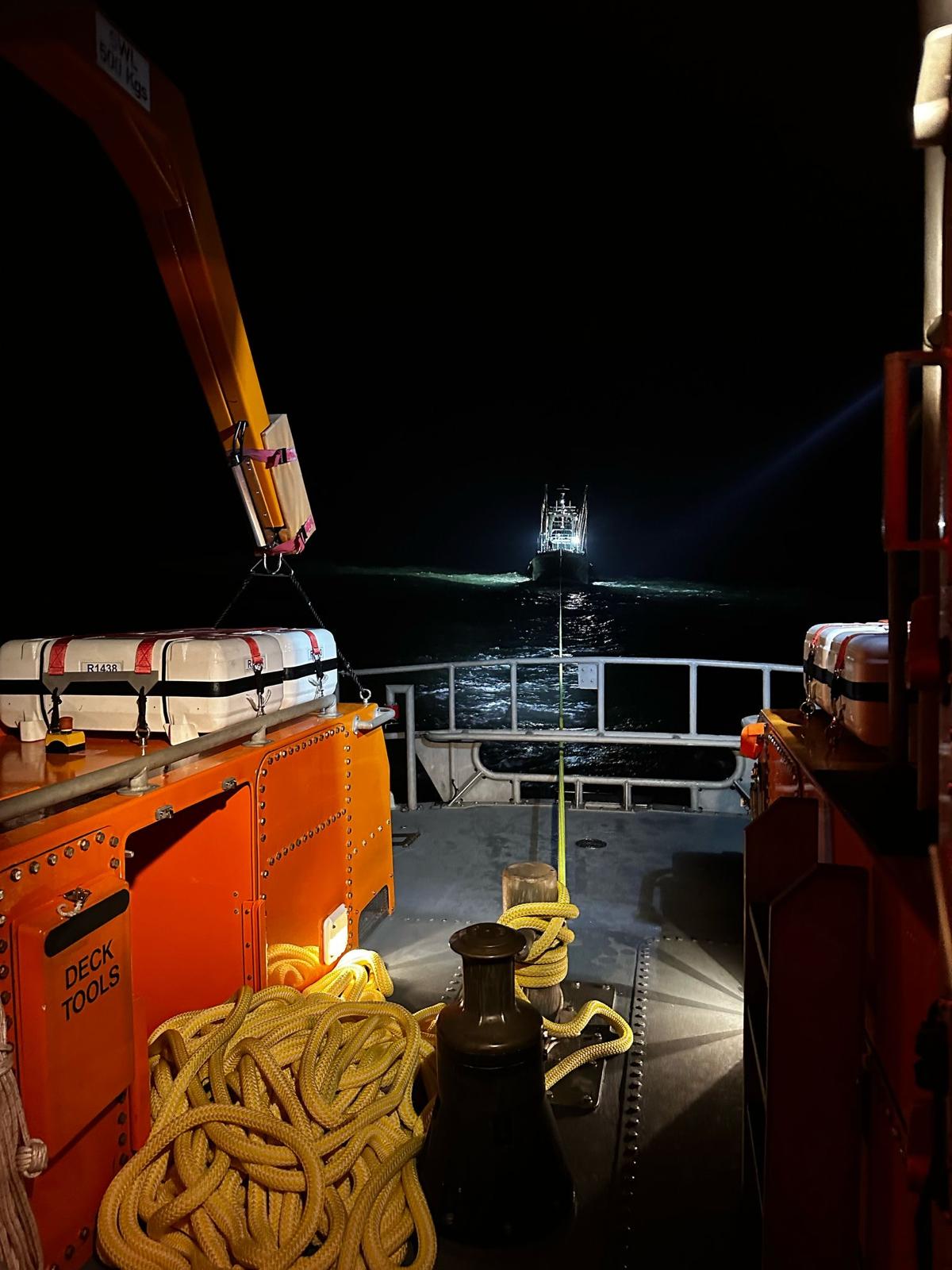 Torbay Lifeboat in a night-time tow of a fishing vessel.