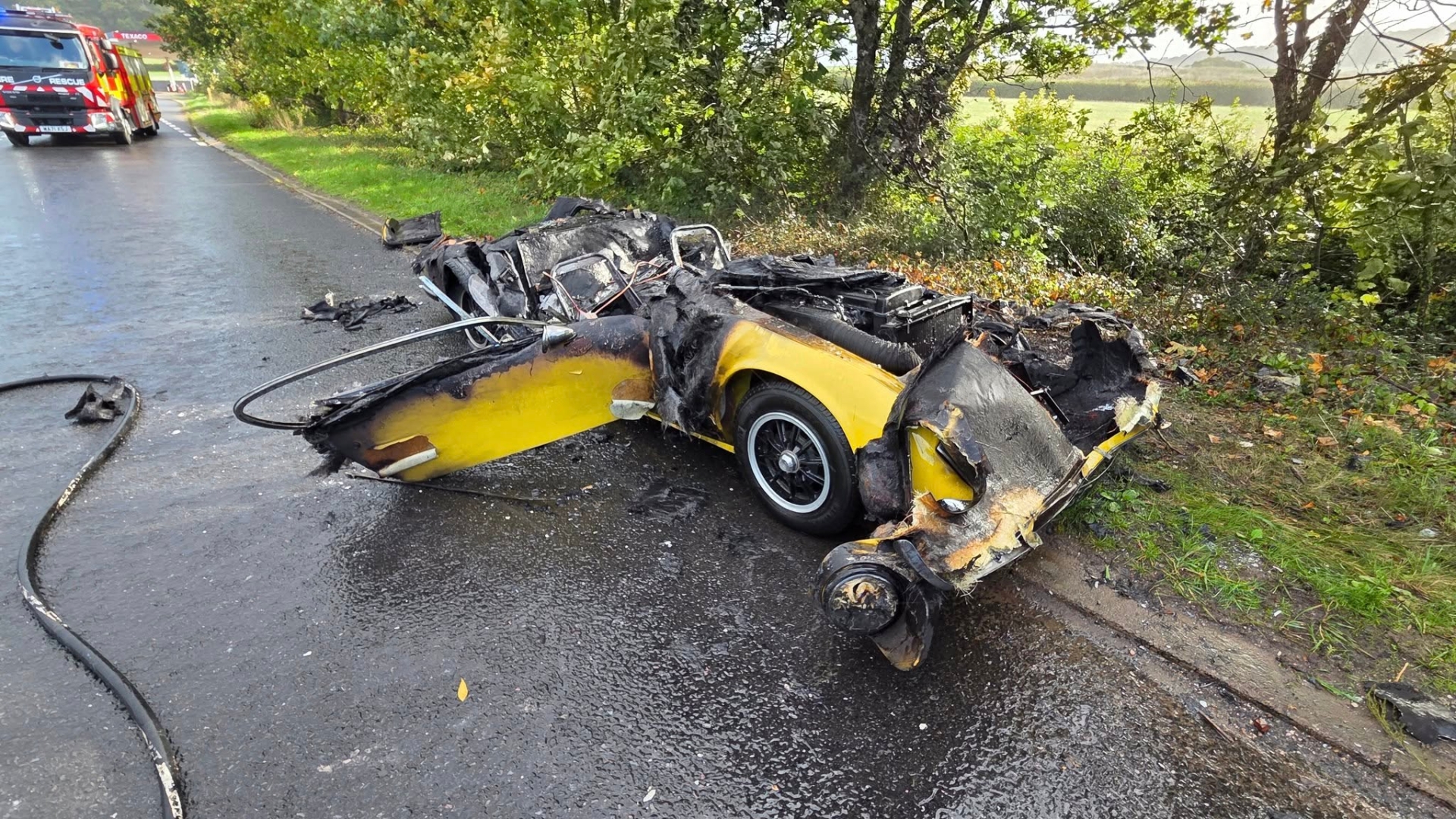 All that is left of a Lotus sports car destroyed in an A38 fire