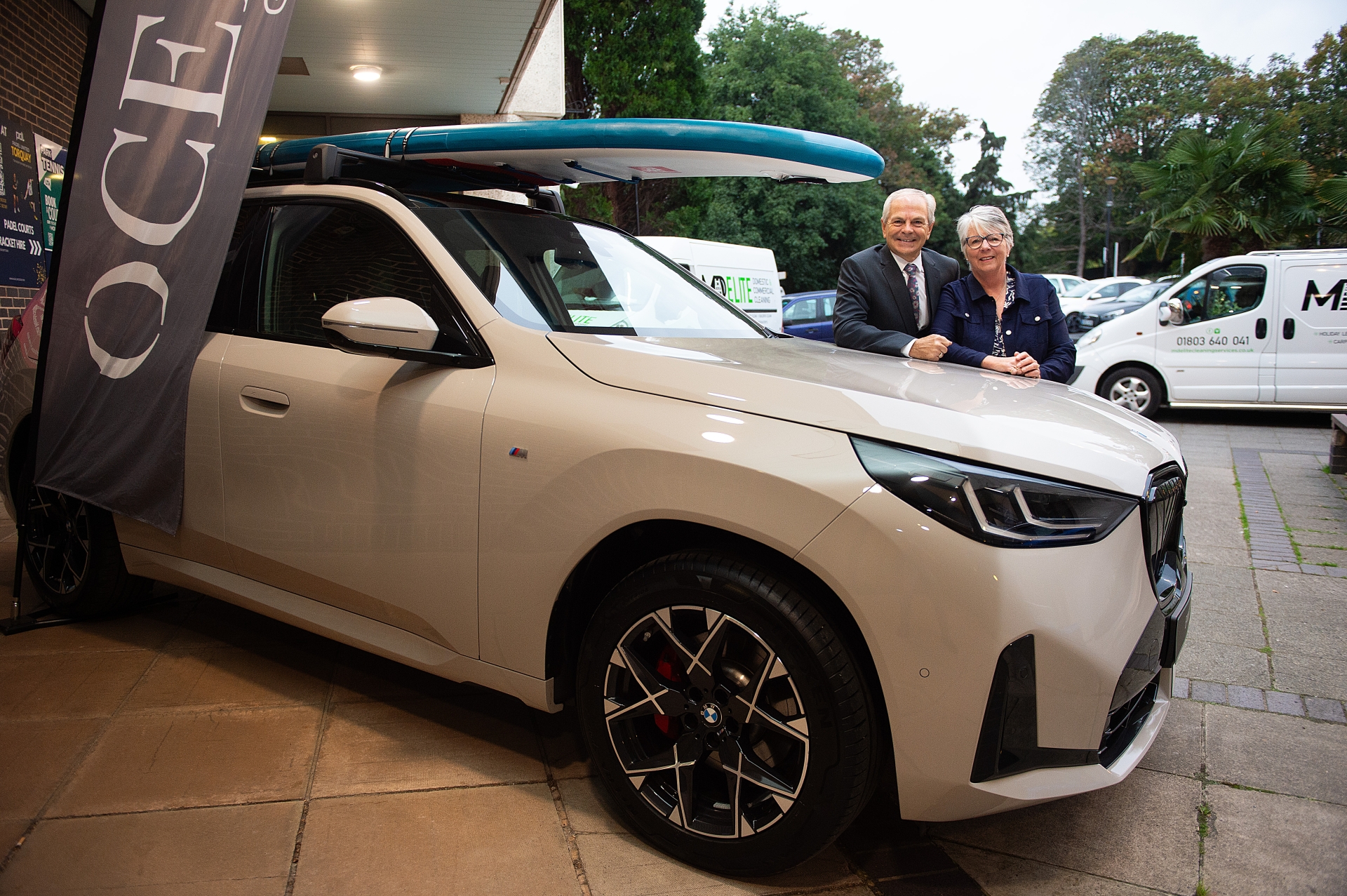 Torbay Business Forum chair Steve Reynolds and Carolyn Custerson, CEO of the English Riviera BID Company pose for an Ocean BMW luxury car moment