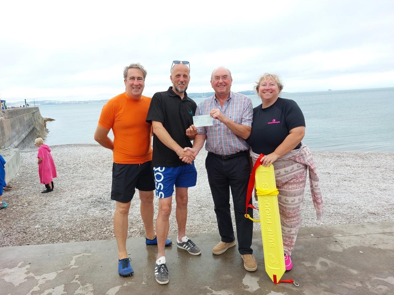 Chris Bryson,centre, presents a cheque to HealthScape members, from left, Andy Thompson, Paul Richards and Sue Dolphin