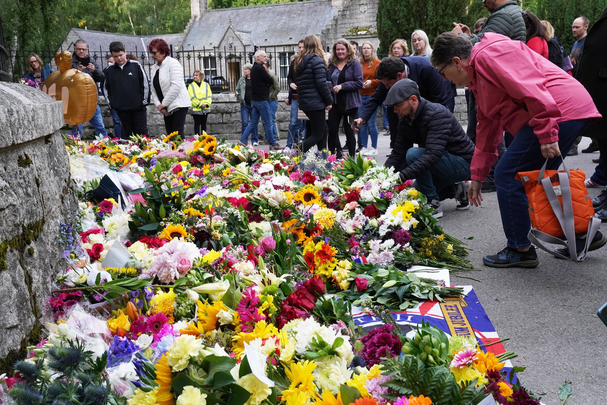 Floral tributes are laid at the gates of Balmoral in Scotland following the death of Queen Elizabeth II on Thursday.