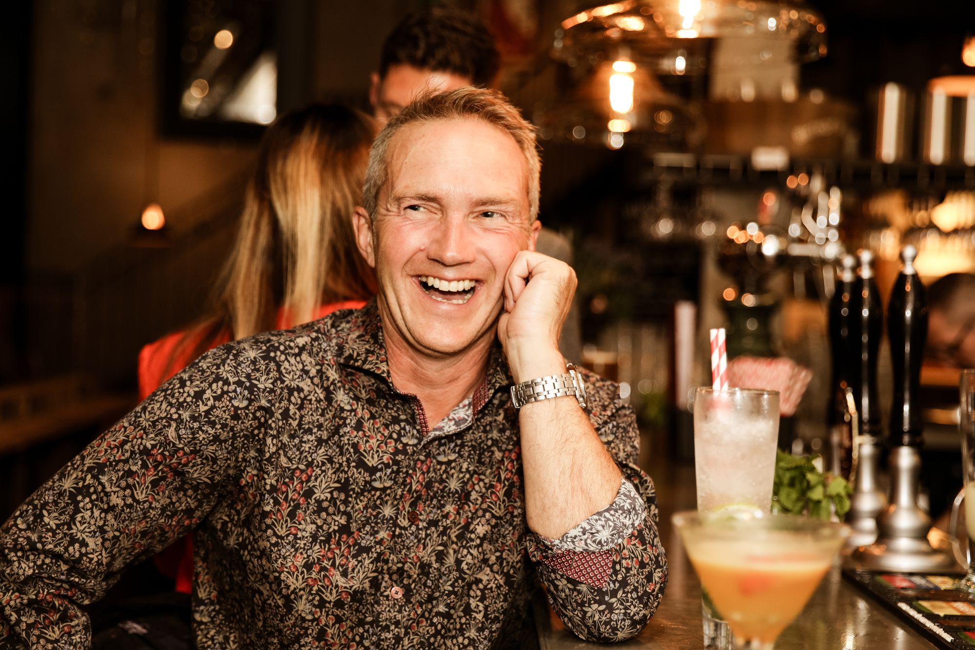 Man wearing floral shirt, laughing