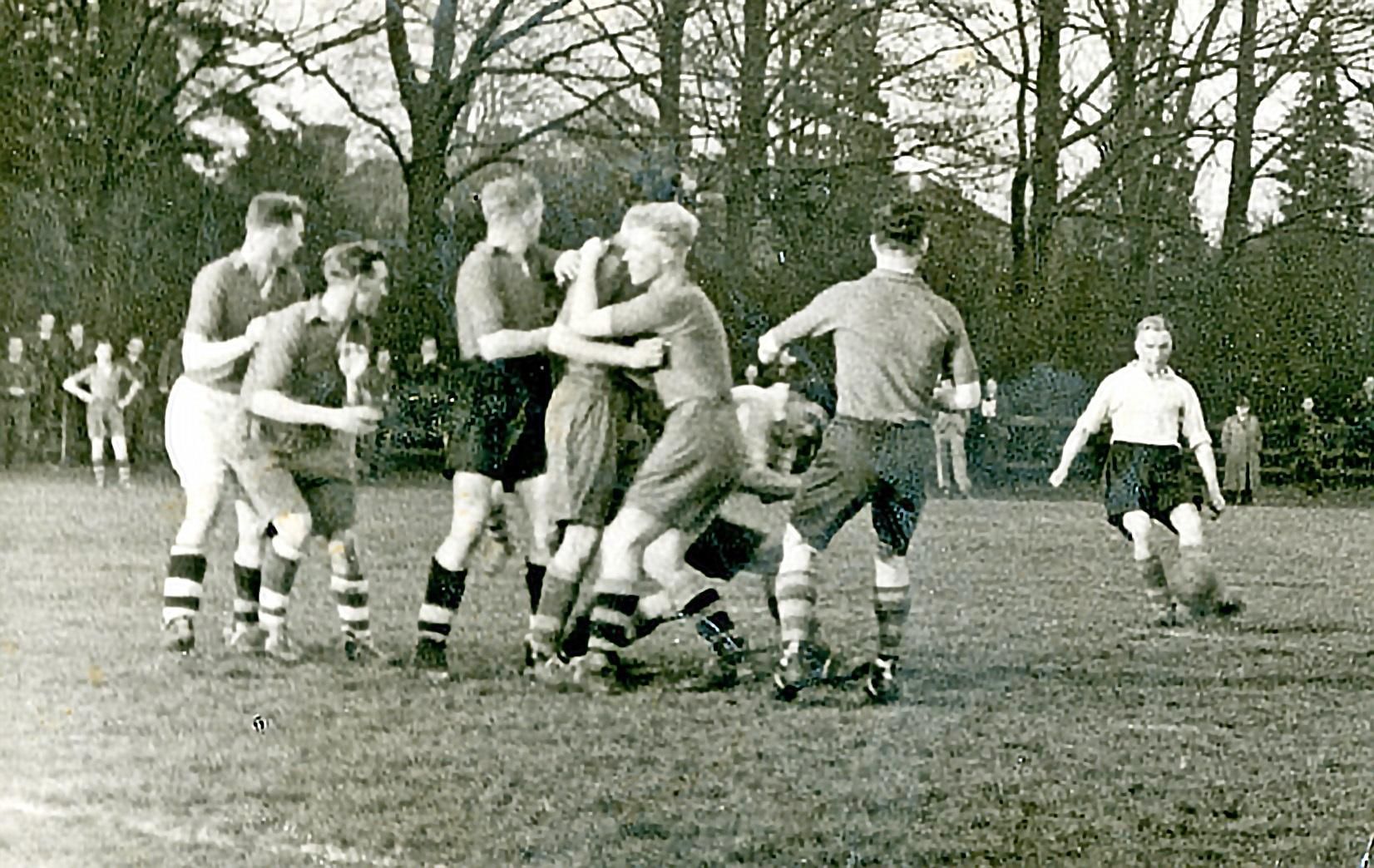 Raich Carter crosses as Dad, second left, waits in anticipation