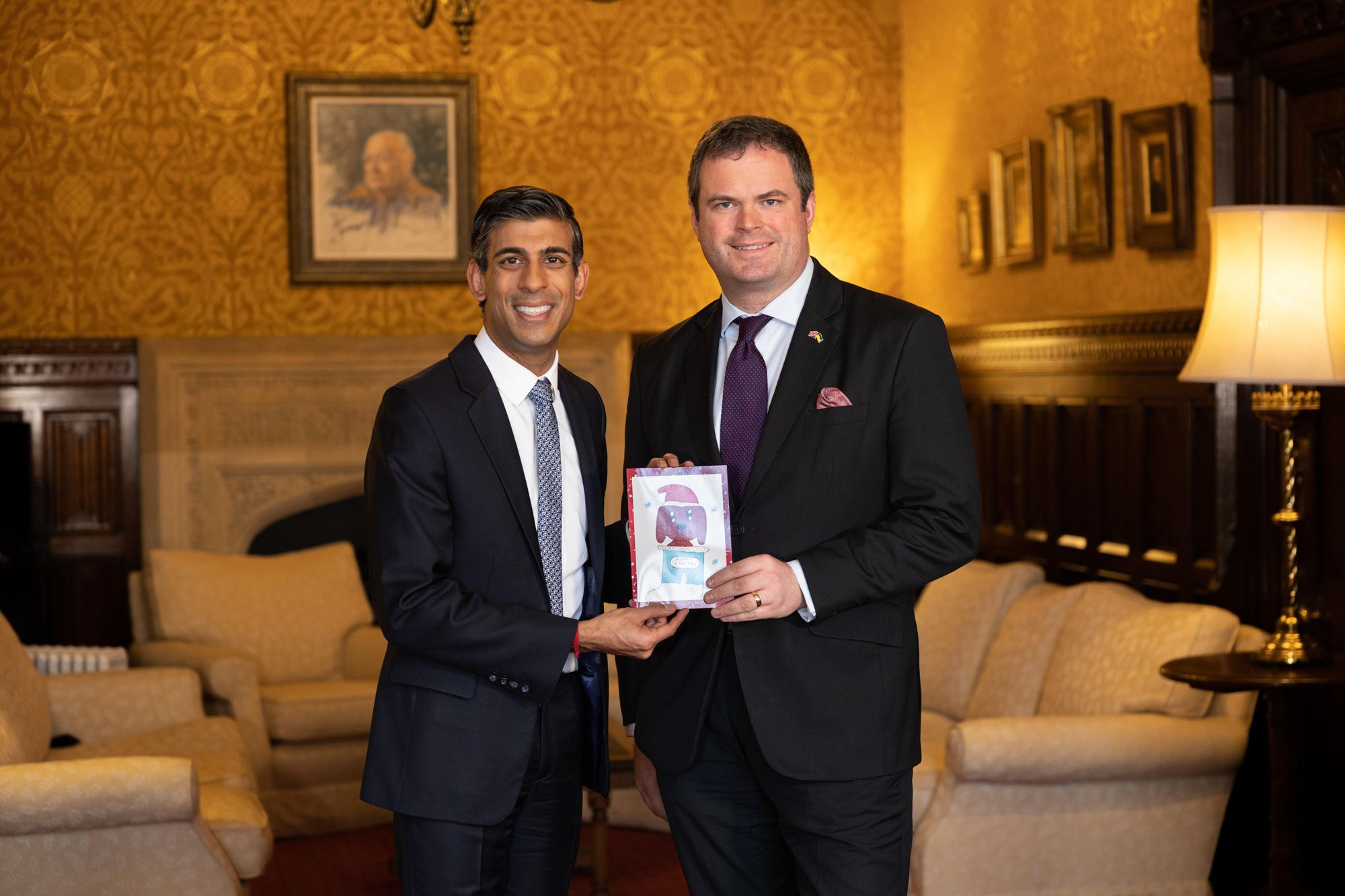 Torbay MP Kevin Foster presents the Christmas card to Prime Minister Rishi Sunak
