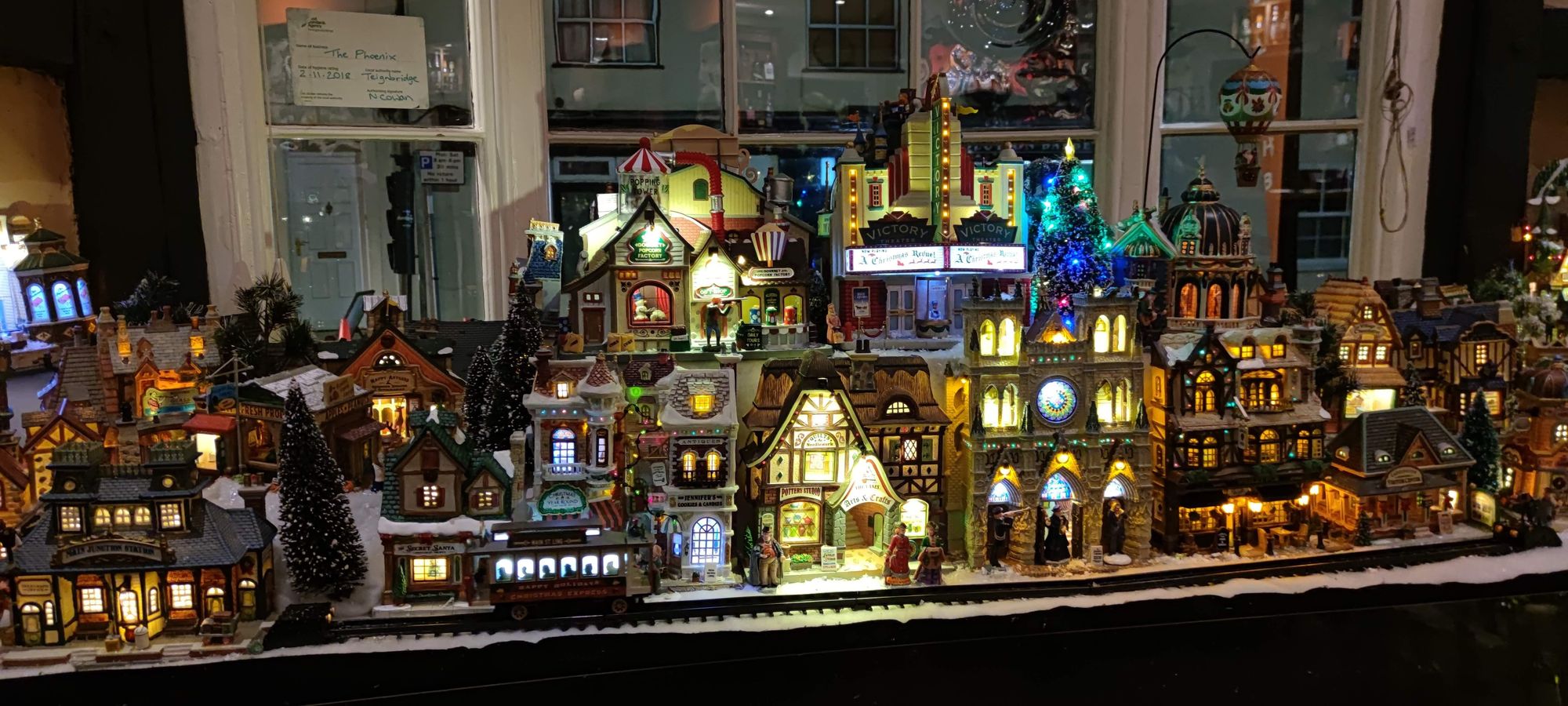 The Christmassy village decoration in the window of The Phoenix 