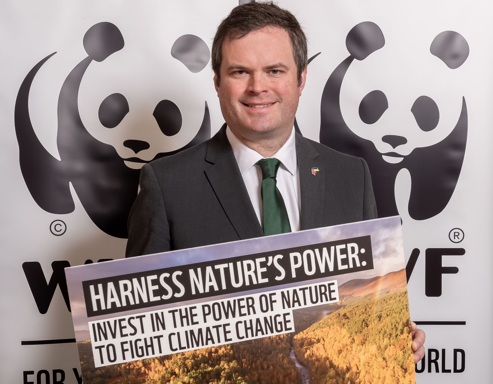 MP Kevin Foster with a WWF climate action pledge poster 