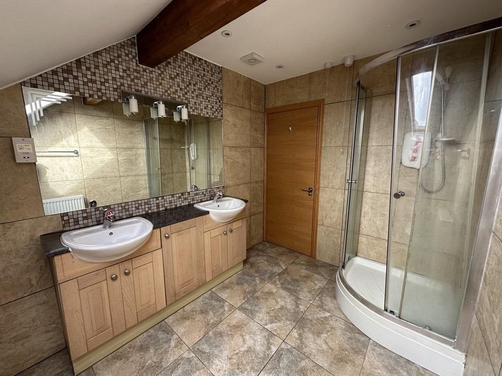 The shower room with twin wash hand basins set in a vanity unit. Credit: John Lake estate agents