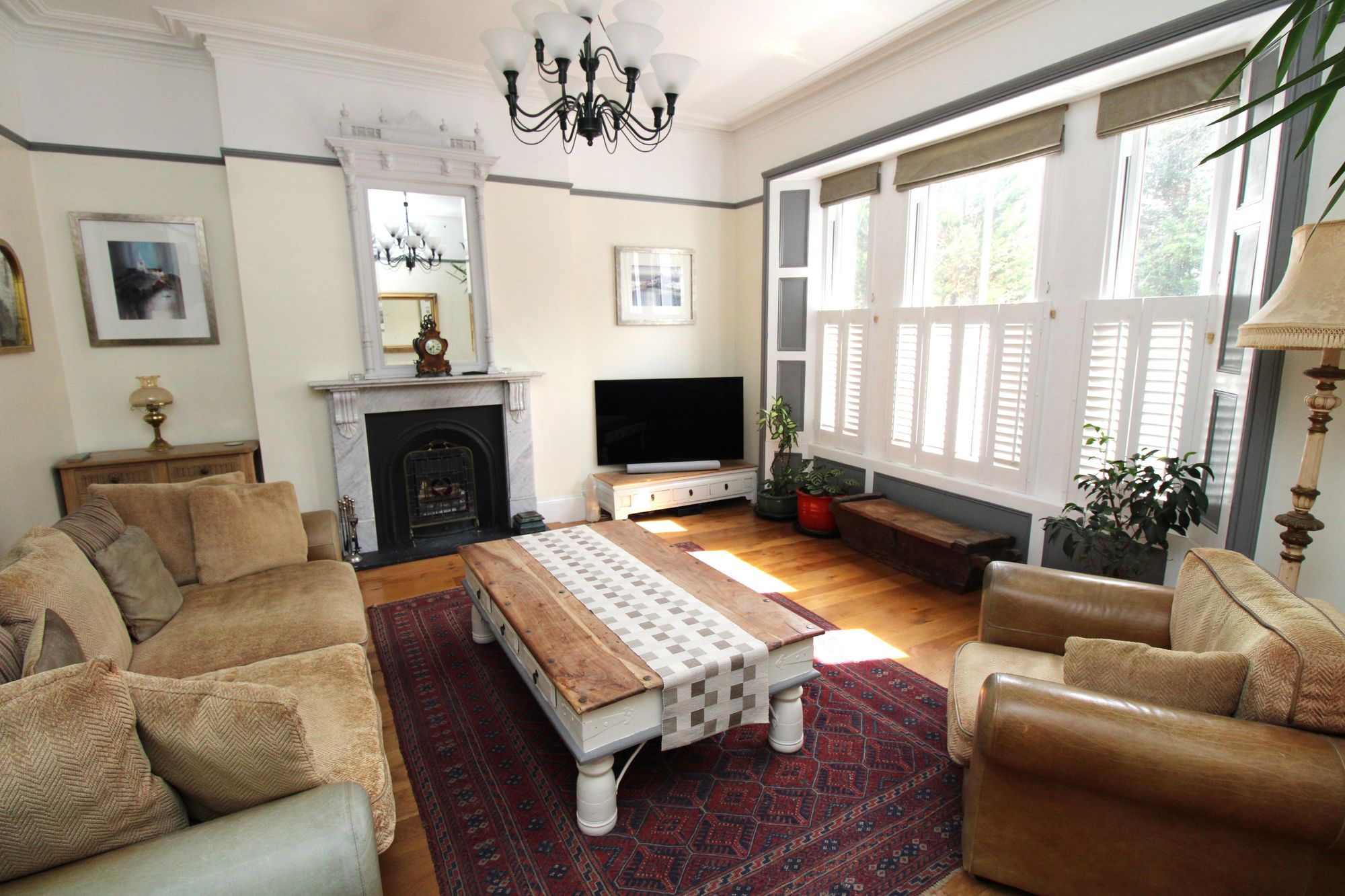 The lounge features high cornice ceilings, a ceiling rose and an original marble fireplace. Credit: Amanda Ayshford