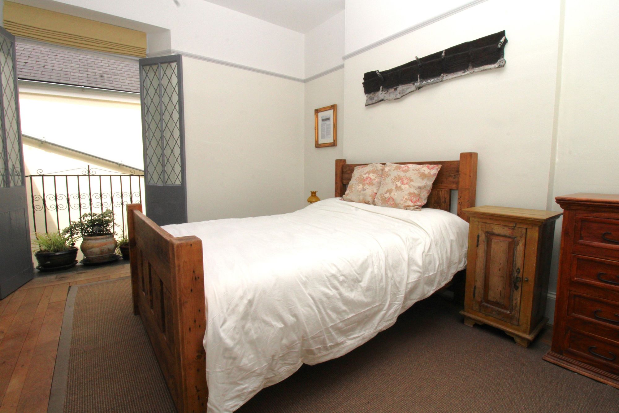 Bedroom two has a Juliette balcony overlooking the inner courtyard. Credit: Amanda Ayshford